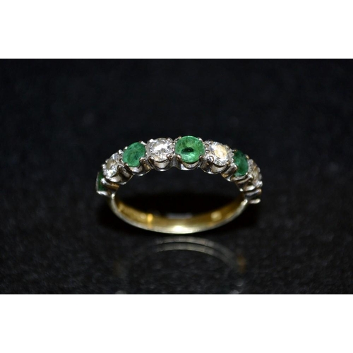 3413 - A diamond and emerald nine stone half eternity ring, alternate set with five emeralds and four diamo... 