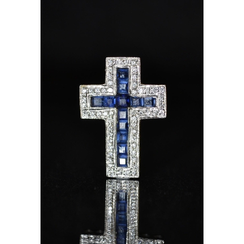 3422 - A dark blue sapphire and diamond cross pendant, central cross of twelve dark blue square cut sapphir... 