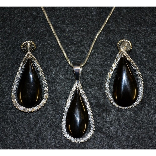 3423 - An Italian BKP pendant necklace, black teardrop stone within a white metal chain link surround, susp... 