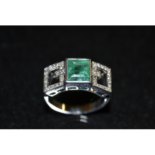 3424 - An emerald and diamond ring, central rectangular emerald baguette, flanked by open diamond encrusted... 