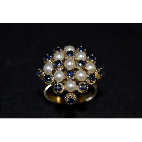 3432 - A sapphire and cultured pearl cluster ring, arching square lattice of alternating cultured pearls an... 