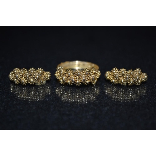 3453 - A continental yellow metal ring and earrings suite, floral crested ring with chain drop side, indist... 