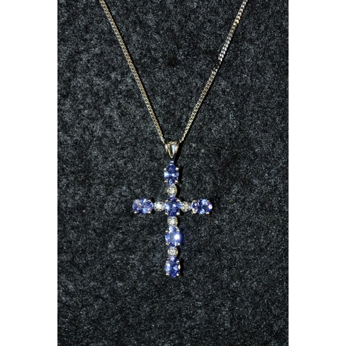 3458 - A tanzanite and 9ct gold cross pendant necklace, white gold mount and chain, stamped 375, 44cm long,... 