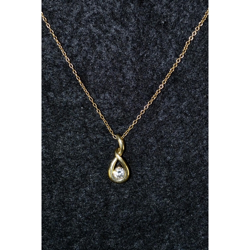 3462 - A 9ct gold teardrop pendant necklace, tied ribbon body inset with a single white stone, stamped 9k, ... 