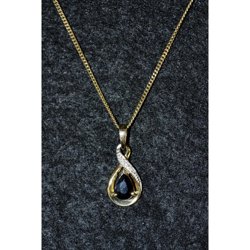 3470 - A sapphire and diamond pendant, deep blue teardrop sapphire beneath a twisting mount inset with thre... 