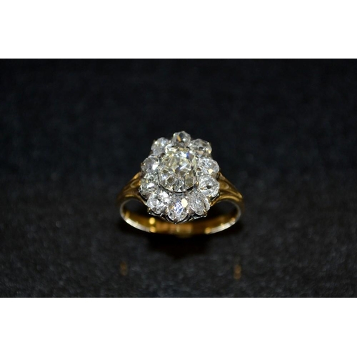 3479 - A 19th century diamond cluster ring. central oval cut diamond approx 1.15ct, raised above a band of ... 