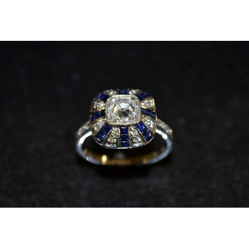 3480 - An Art Deco sapphire and diamond ring, central cushion cut diamond surrounded by alternating diamond... 