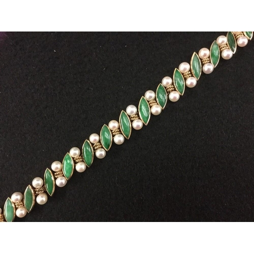 3484 - An emerald and pearl bracelet, sixteen navette emerald cabochons, each divided by a double ring and ... 