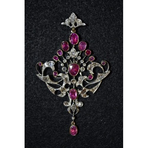 3488 - A Burmese ruby and diamond pendant, open swag cresting body adorned with fourteen oval pinky red rub... 