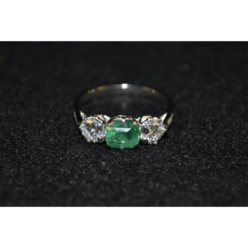 3489 - An emerald and diamond trilogy ring, central square cushion cut emerald, approx 0.70ct, flanked by a... 