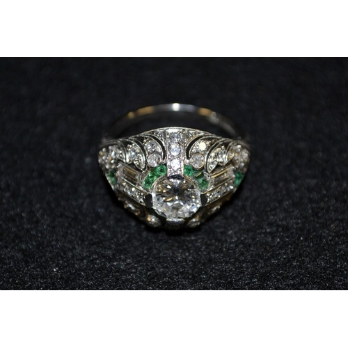 3494 - An Art Deco diamond and emerald cluster ring, central round brilliant cut diamond, approx 1ct, surro... 
