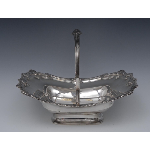 72 - A George III silver shaped rectangular boat shaped swing-handled cake or bread dish, gadrooned borde... 