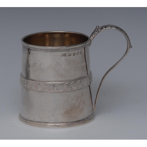 74 - A George III silver spreading cylindrical child's mug, acanthus-capped scroll handle, applied broad ... 