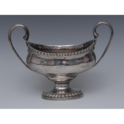 76 - A George III silver two-handled boat shaped pedestal sauce tureen, reeded scroll handles, gadrooned ... 