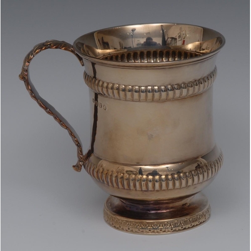 77 - A George III silver waisted campana mug, fluted borders, acanthus scroll handle, spreading foot, 10c... 