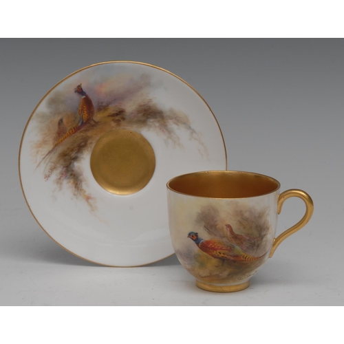 316 - A Royal Worcester cabinet cup and saucer,  painted by Jas Stinton, signed, with pheasants,  gilt int... 