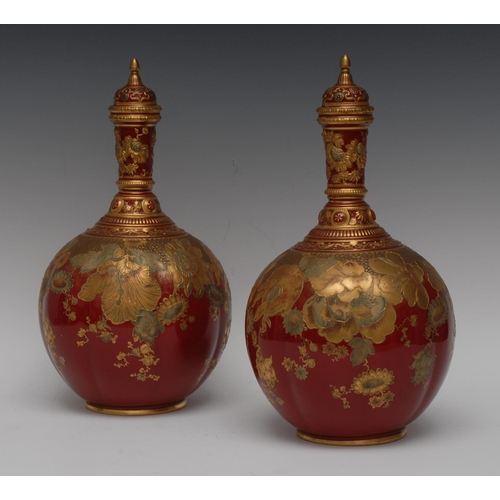 388 - A pair of Derby Crown Porcelain lobed bottle vases and covers, in the Persian taste, decorated in gi... 