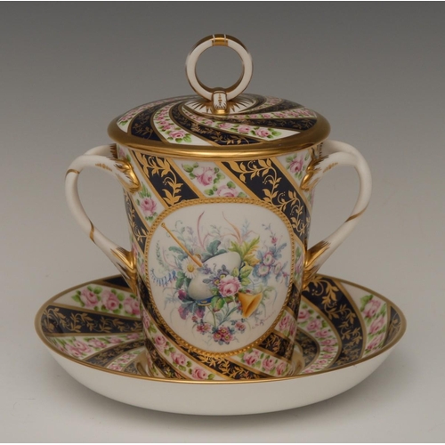 115 - A Lynton porcelain two-handled tapering cylindrical chocolate cup, cover and stand, painted by Stefa... 