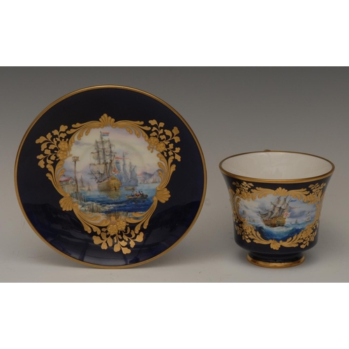 127 - A Lynton porcelain bell shaped teacup and saucer, painted by Stefan Nowaki, signed with galleon, wit... 