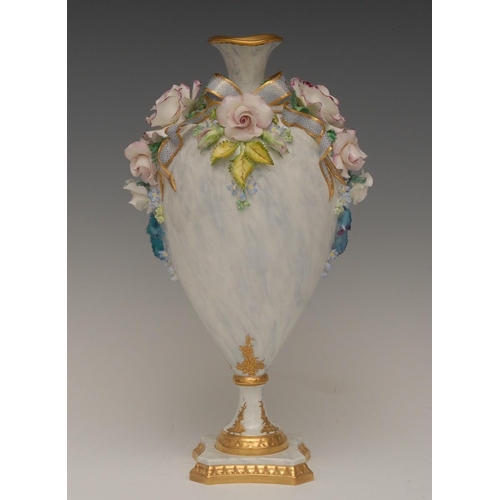 131 - A Lynton pedestal ovoid vase, encrusted with ribbon tied  carnations, forget-me-nots, roses and foli... 