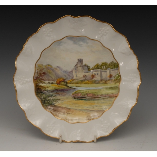 93 - A Royal Crown Derby shaped circular wavy edge plate,  painted by W. E. J. Dean, signed, with a view ... 