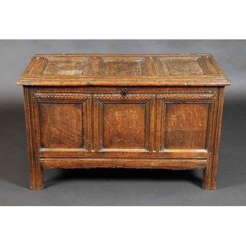 1633 - A 17th century oak three panel blanket chest, of small proportions, hinged top above a chip carved d... 