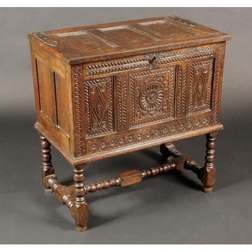 1634 - A 17th century style oak blanket chest, hinged three panel top, the front carved with roundels, loze... 