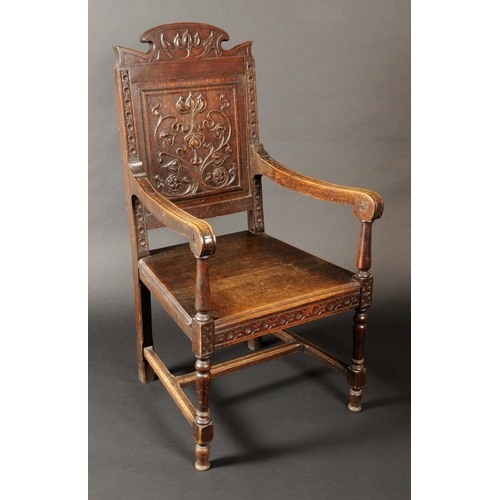 1635 - A 17th century style oak wainscote armchair, shaped cresting and rectangular back carved with stylis... 