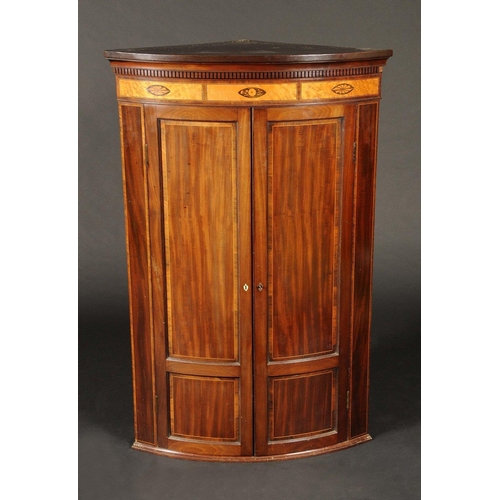 1638 - A 19th century  mahogany bow fronted corner cabinet, moulded and dentil cornice the frieze inlaid wi... 