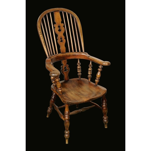 1643 - A 19th century ash and elm Windsor elbow chair, hooped back, shaped and pierced 'Christmas Tree' spl... 