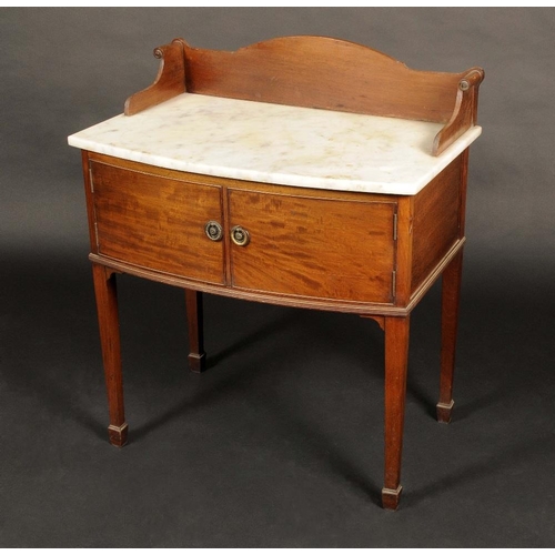 1649 - A 19th century mahogany bow fronted washstand, marble top with three-quarter gallery, carved with sc... 