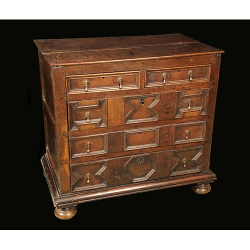 1662 - A Charles II oak blockfront chest, oversailing top above two short and three long drawers applied wi... 