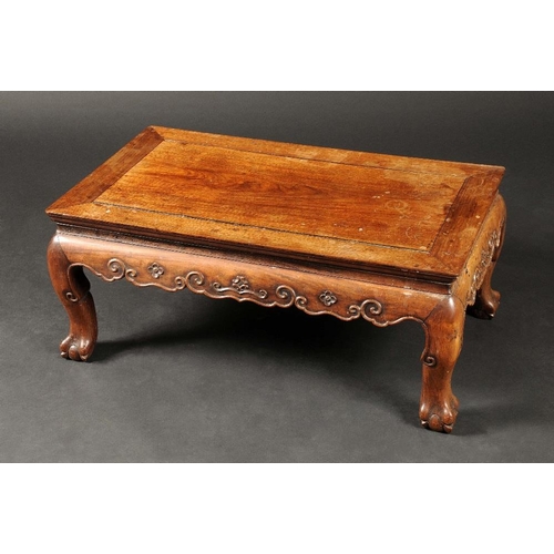 1666 - A Chinese padouk wood low tea table, moulded top above a shaped frieze carved with scrolls, ball and... 