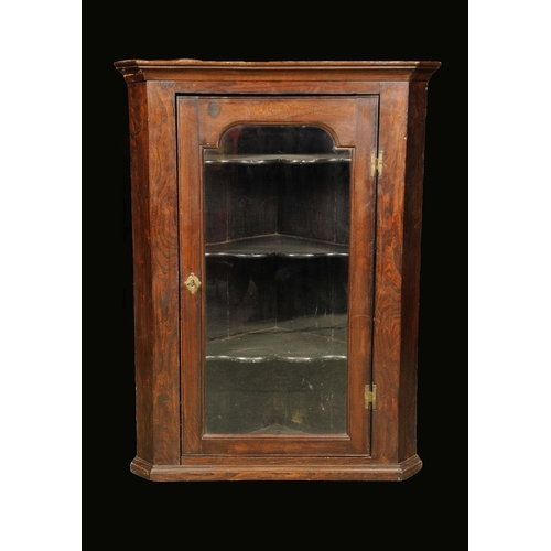 1693 - A George III elm and oak splay fronted wall hanging corner cupboard, moulded outswept cornice above ... 