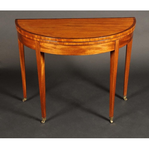 1702 - A George III mahogany demi-lune card table, crossbanded folding top enclosing an inset baize lined p... 