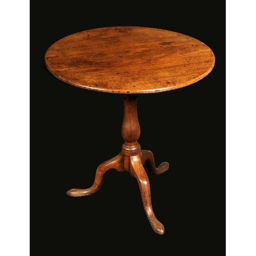 1712 - A George III mahogany tripod occasional table, circular top tilting and rotating on a birdcage, balu... 