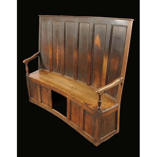 1715 - A George III oak and elm curved settle, tall back with six rectangular panels, downswept arms on tur... 