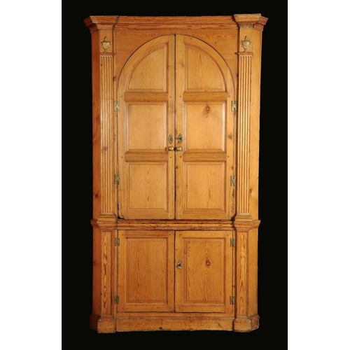 1723 - A George III pine splay fronted floor standing corner cupboard, moulded cornice above a pair of arch... 