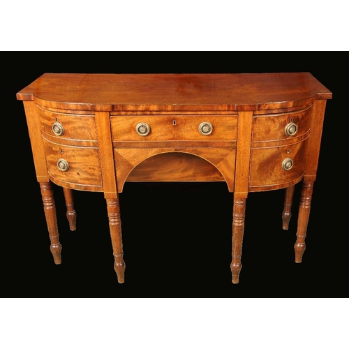 1736 - A George IV mahogany shaped bow fronted sideboard, slightly over sailing top above a cockbeaded frie... 