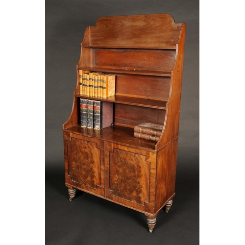 1738 - A George IV mahogany waterfall bookcase, shaped back above three terraced shelves, moulded borders, ... 