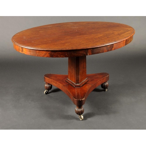 1739 - A George IV plum pudding mahogany oval breakfast table, moulded tilting top, canted triform column, ... 