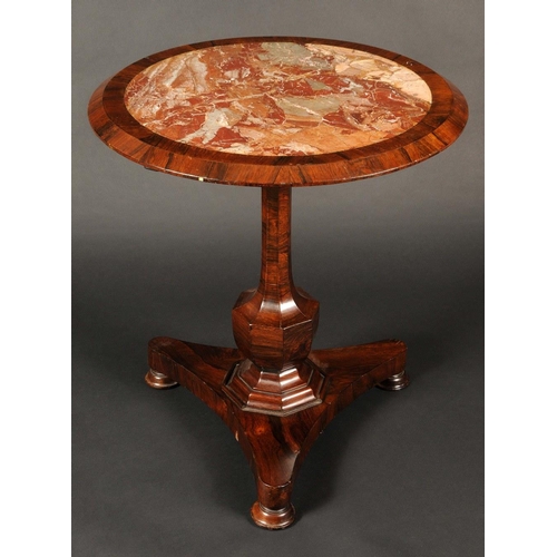 1740 - A George IV rosewood centre table, the tilting top inset with a marble panel, panelled baluster colu... 