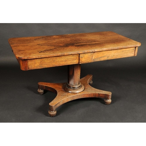 1742 - A George IV rosewood rounded rectangular library table, oversailing top above a pair of frieze drawe... 