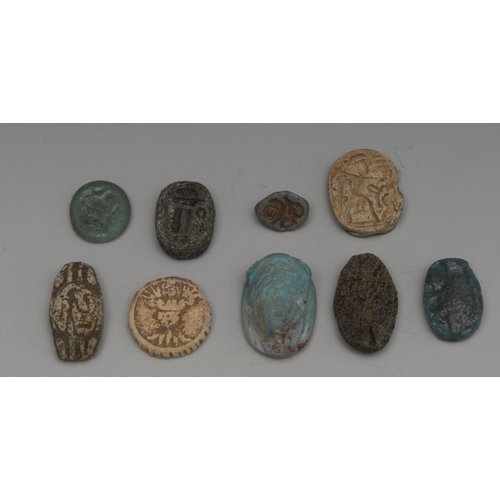 2570 - An Egyptian blue Faience amulet as a frog; others, glass, ceramic and bone (9)