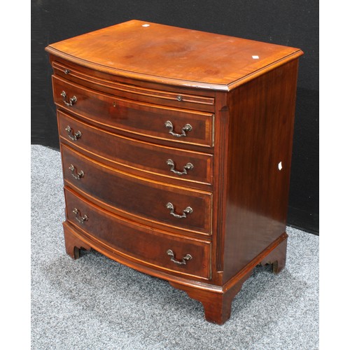 414 - A George III style crossbanded mahogany bow fronted bachelor’s chest, brushing slide above four draw... 