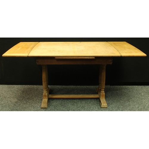 415 - An oak refectory type draw-leaf dining table