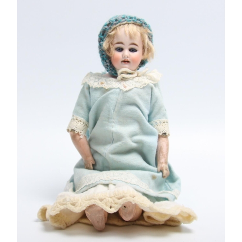 306 - A bisque head and fashion shaped kid leather body doll, sleeping blue glass eyes, open red lips reve... 