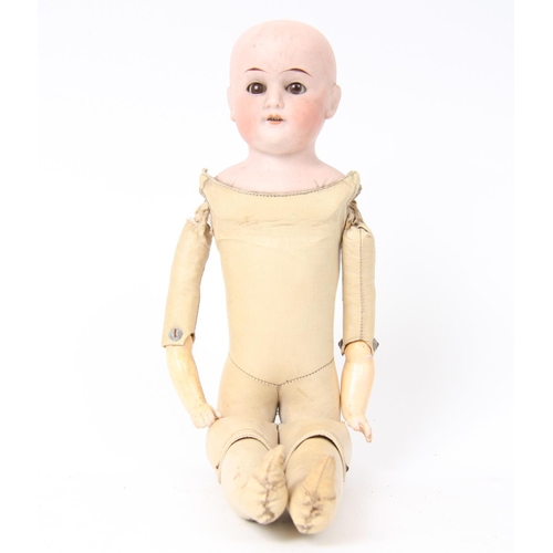 308 - A German bisque head and shoulder doll with a shaped kid leather body, sleeping brown glass eyes, pa... 