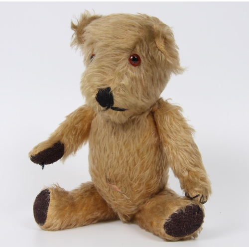 320 - A blonde mohair teddy bear, amber and black plastic eyes, vertically black stitched nose, cloth type... 