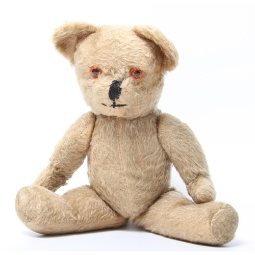 322 - A blonde mohair fixed keywind musical teddy bear, amber and black plastic eyes, vertically black sti... 